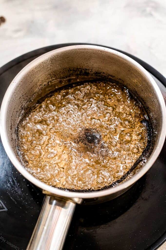 Saucepan boiling a simple vanilla syrup