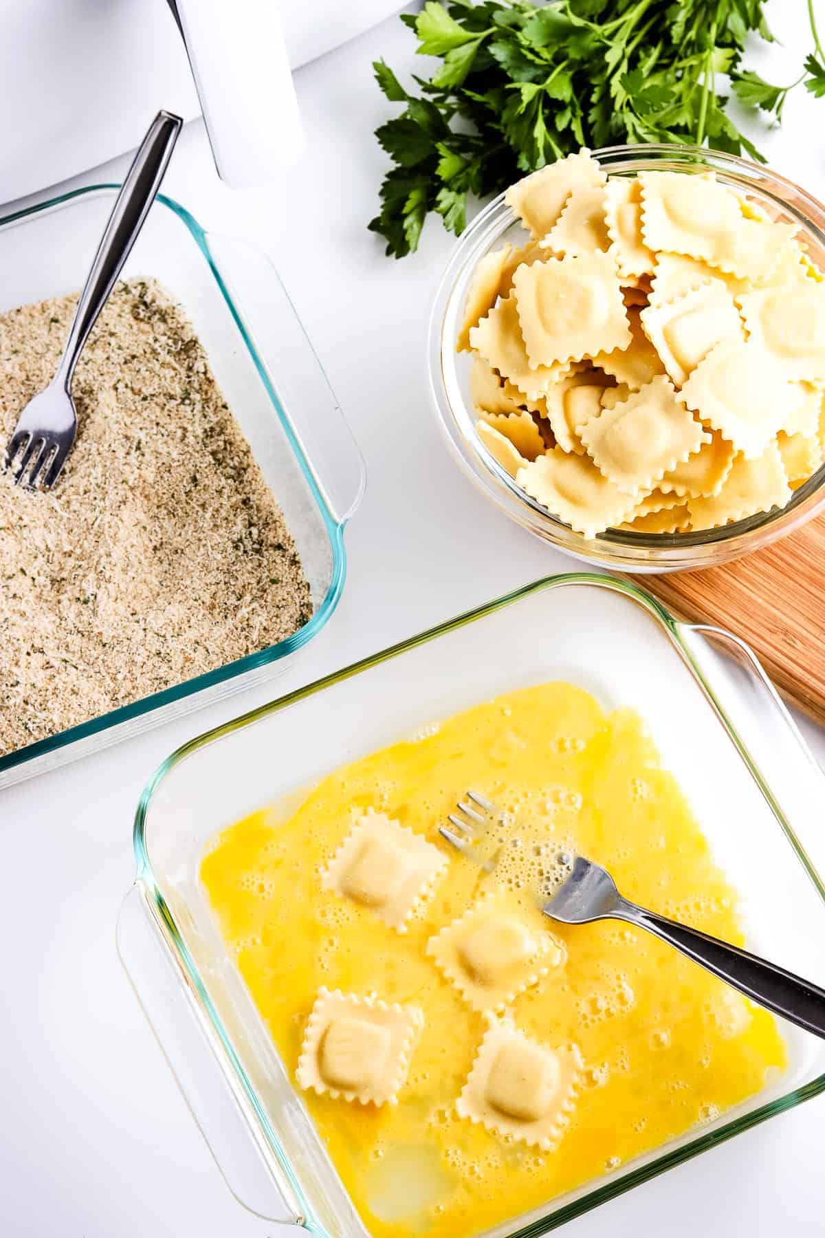 Dipping ravioli in egg wash mixture