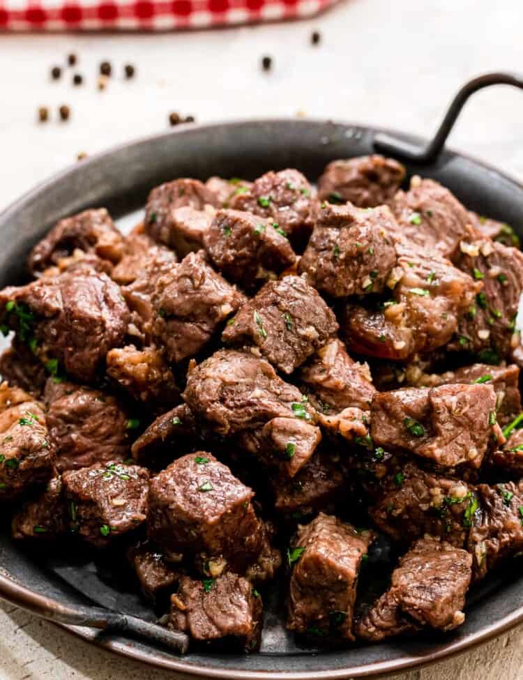 Steak Bites with Garlic Butter on black serving platter