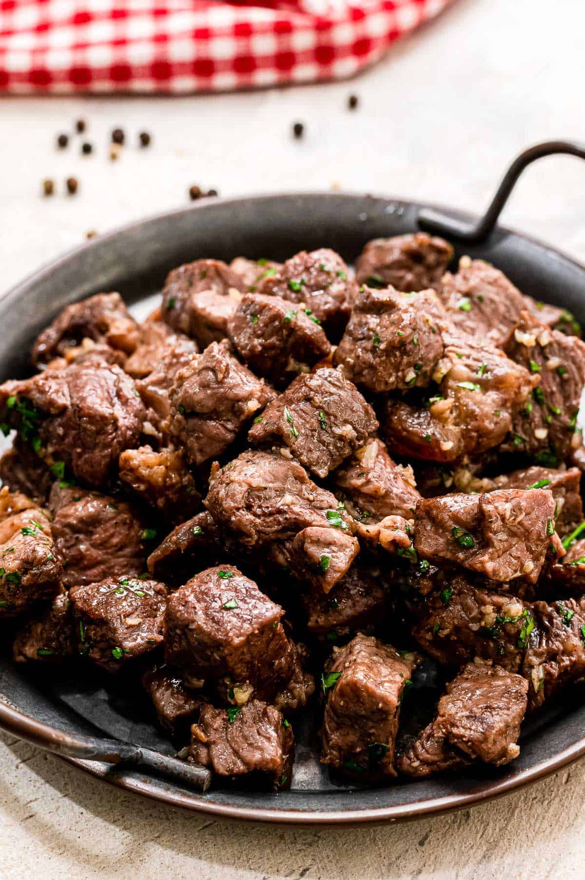 Steak Bites with Garlic Butter on black serving platter