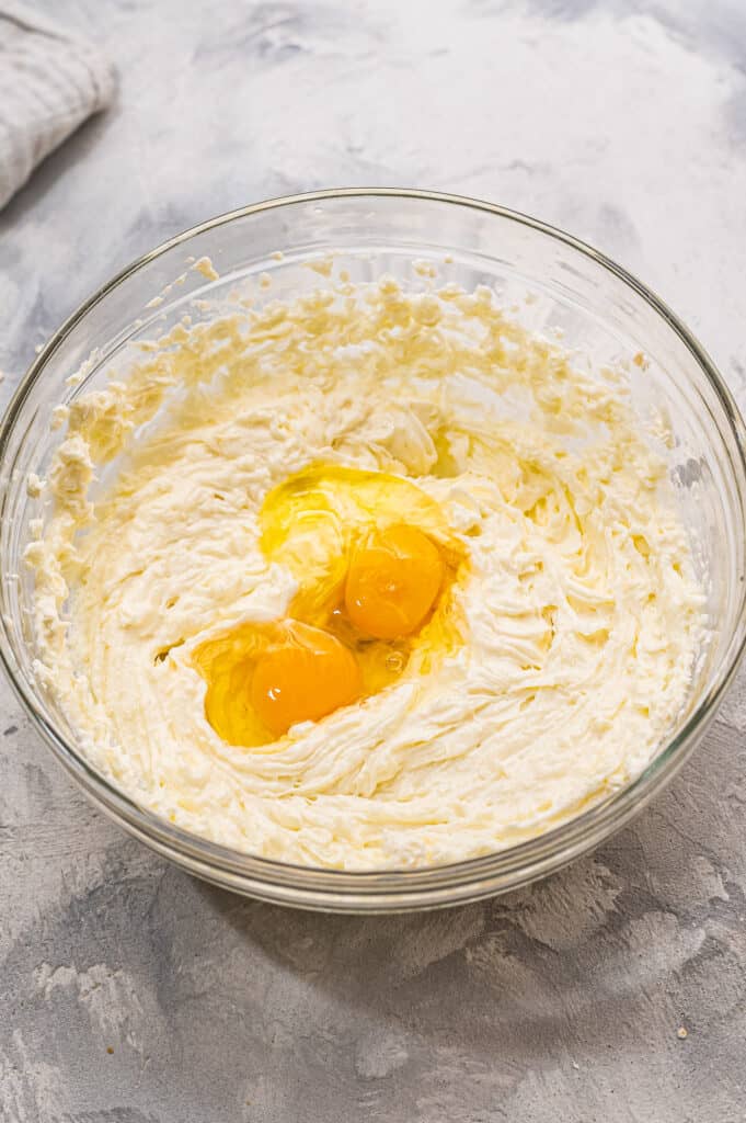 Glass bowl with ingredients for cheesecake layer