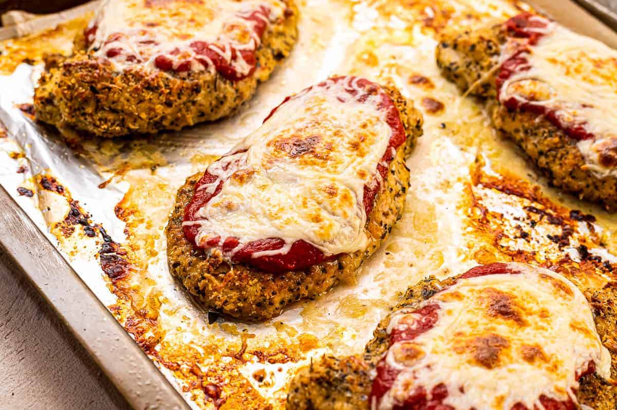 Sheet pan with chicken parmesan on it