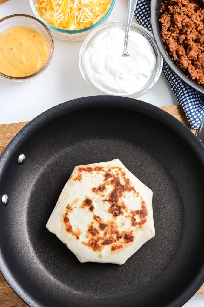 Skillet cooking a crunchwrap