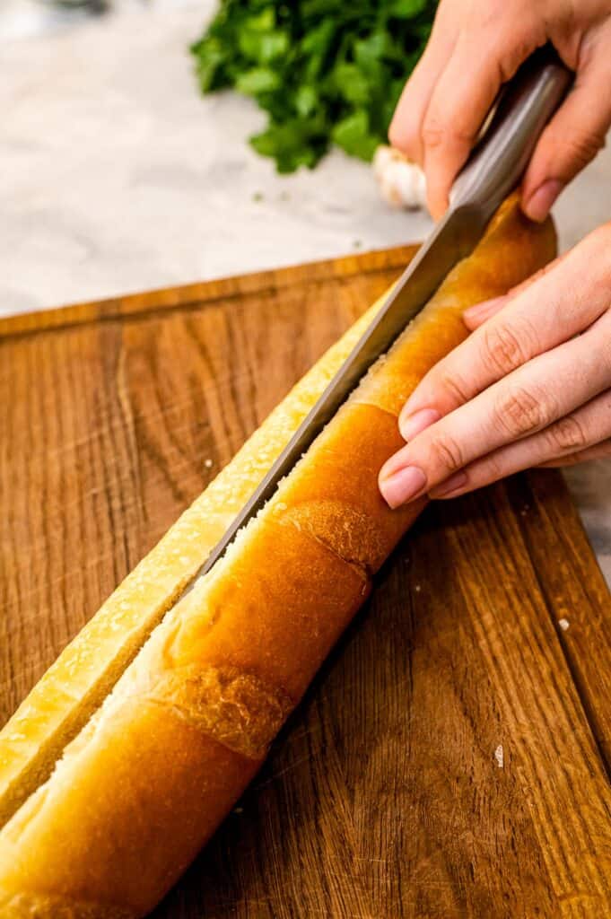Slicing a loaf of French Bread with knife