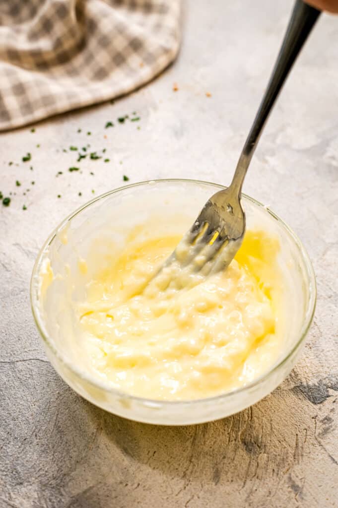 Softened butter in glass bowl