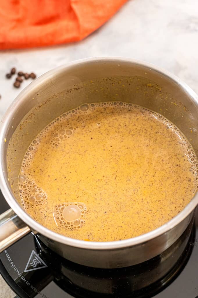 Saucepan with ingredients for pumpkin creamer after stirring