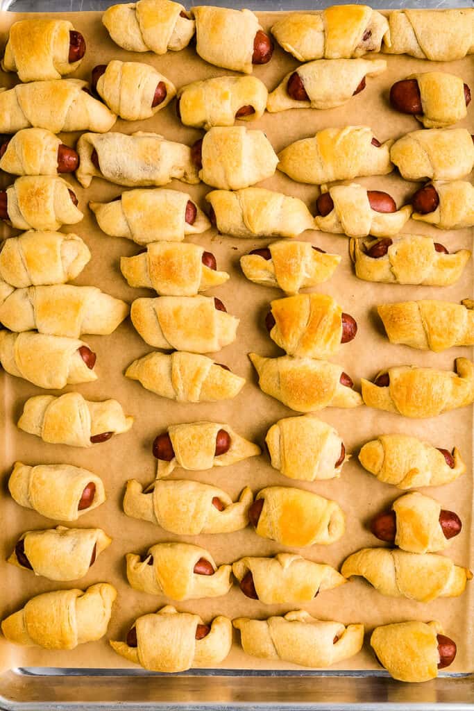 Overhead image of baked pigs in a blanket on a baking sheet