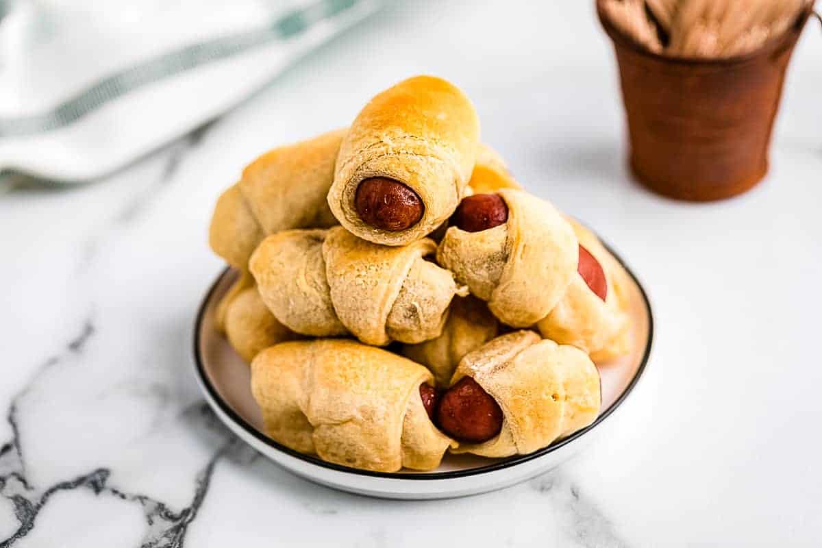 Plate with a stack of mini crescent dogs