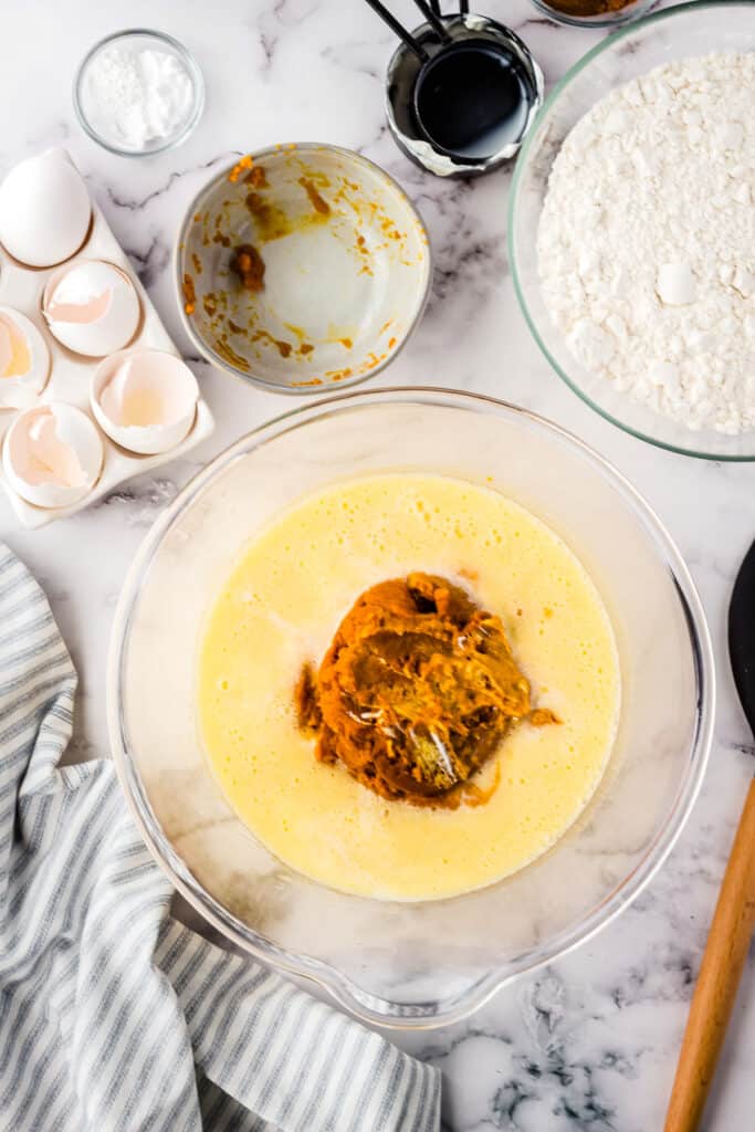 Wet ingredients in glass bowl for pumpkin cake