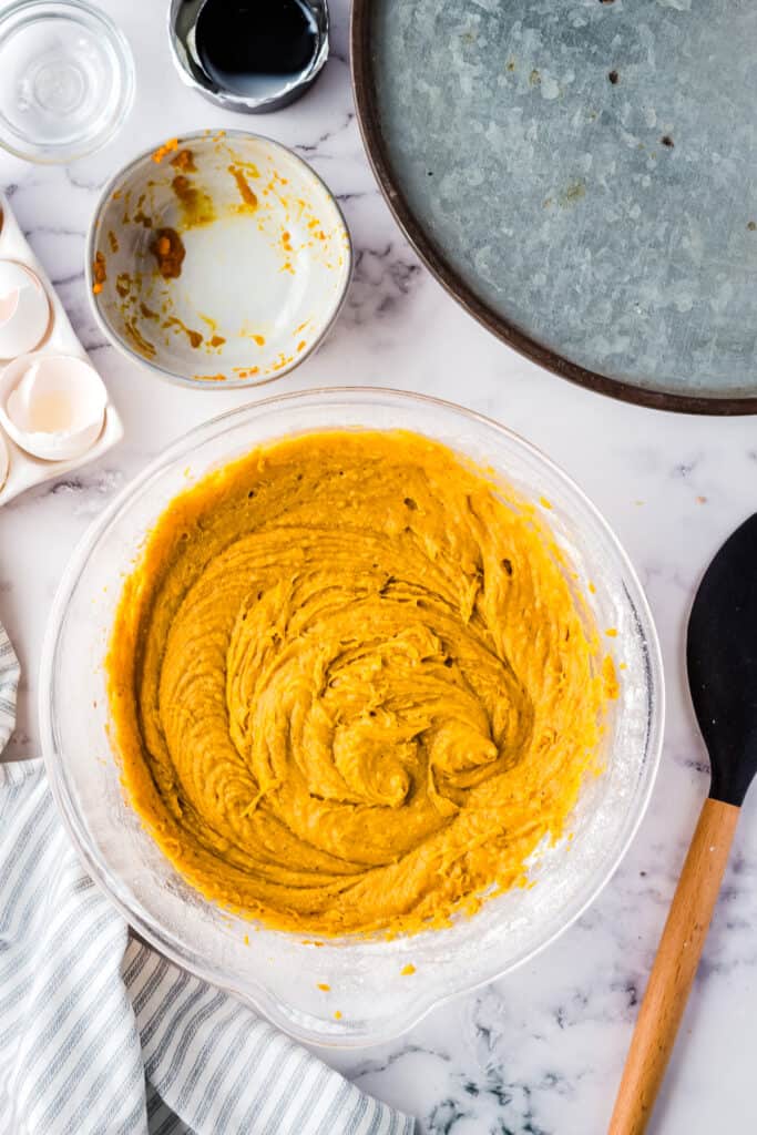 Pumpkin cake batter mixed in glass bowl