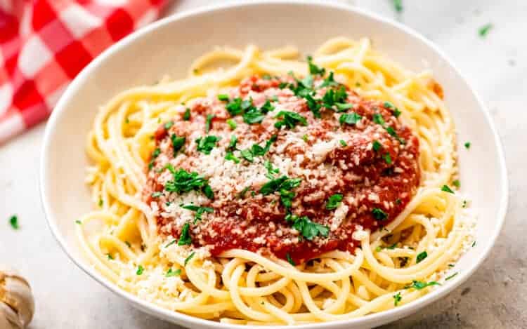 White bowl with spaghetti noodles and sauce