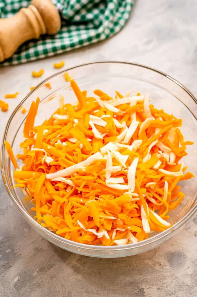 Glass bowl with shredded mozzarella and cheddar cheese