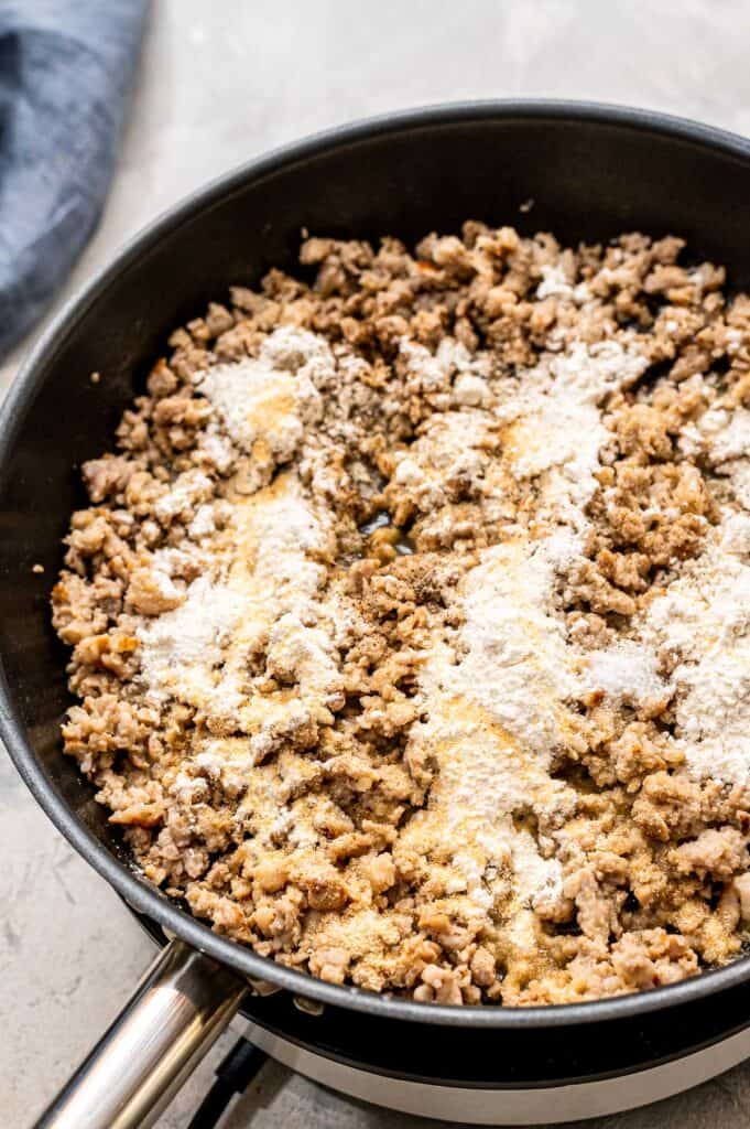 Flour over the top of browned sausage in skillet