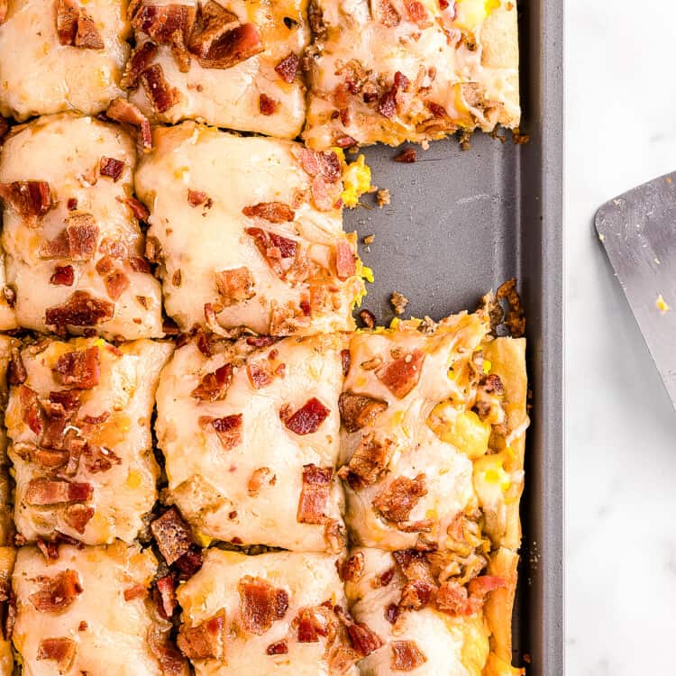 Overhead image of breakfast pizza in pan sliced