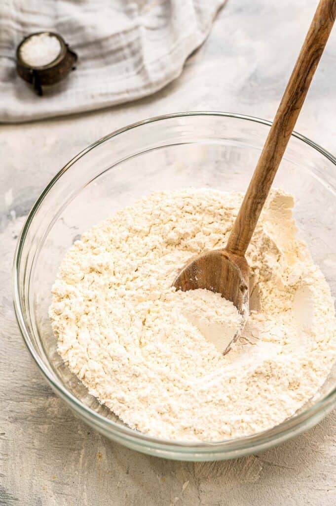 Stirring dry ingredients to mix in glass bowl