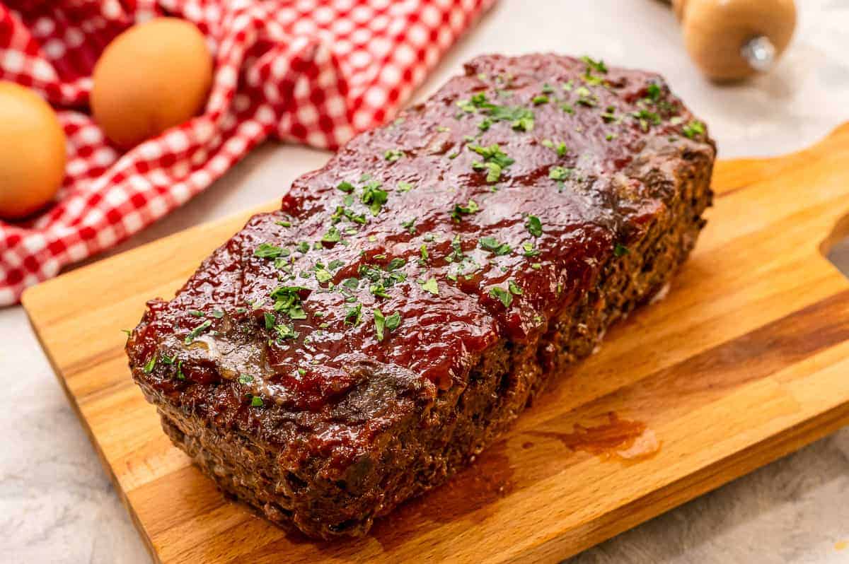 Meatloaf with glaze on cutting board