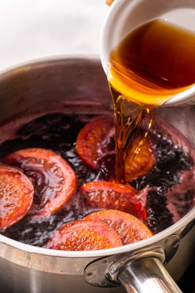 Pouring brandy into mulled wine