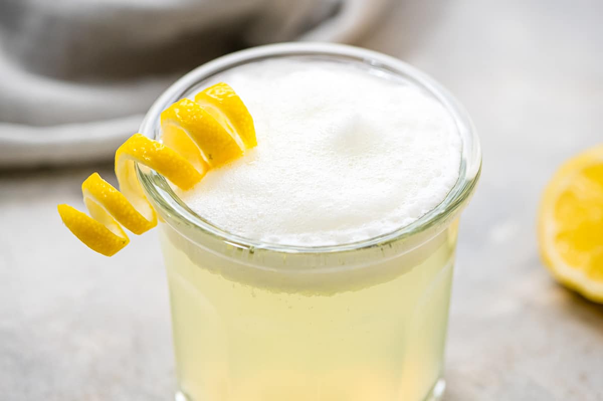 Gin Fizz Cocktail garnished with lemon twist