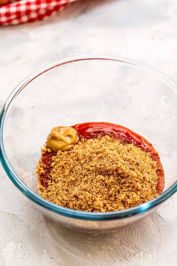 Brown sugar, mustard and ketchup in glass bowl