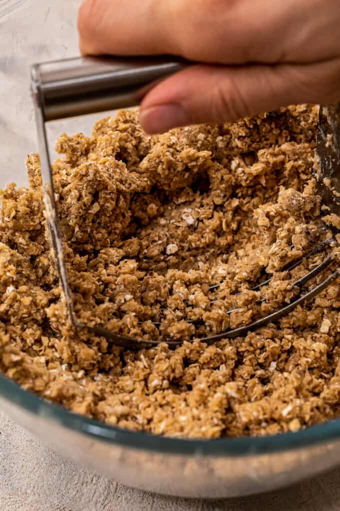 Cutting butter with pastry cutter into streusel topping