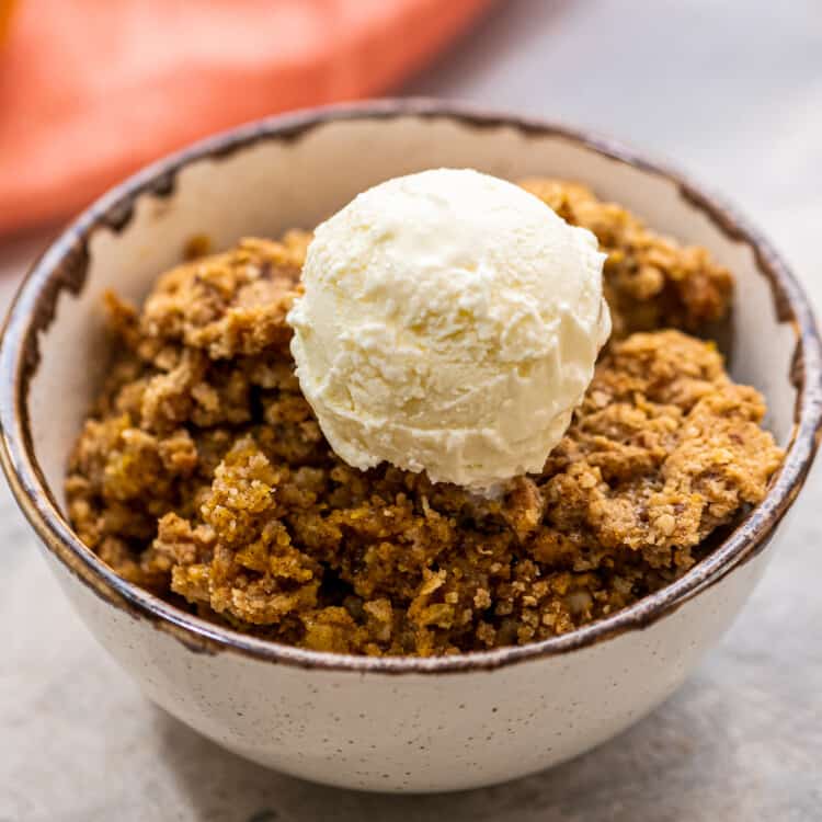 Scoop of Pumpkin Crisp in bowl with vanilla ice cream