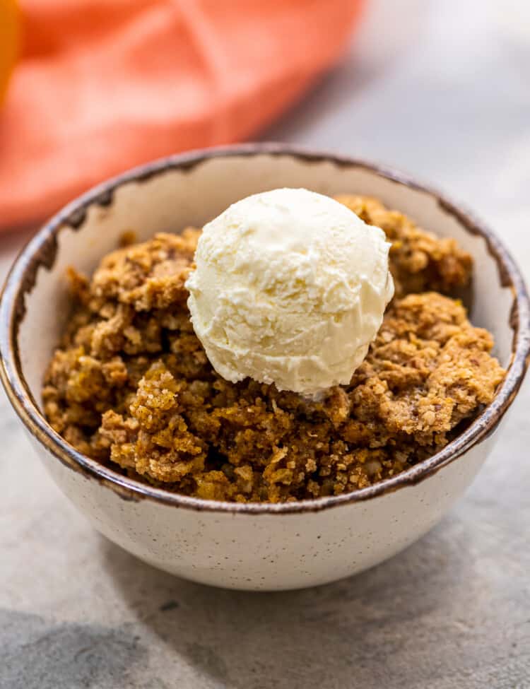 Scoop of Pumpkin Crisp in bowl with vanilla ice cream