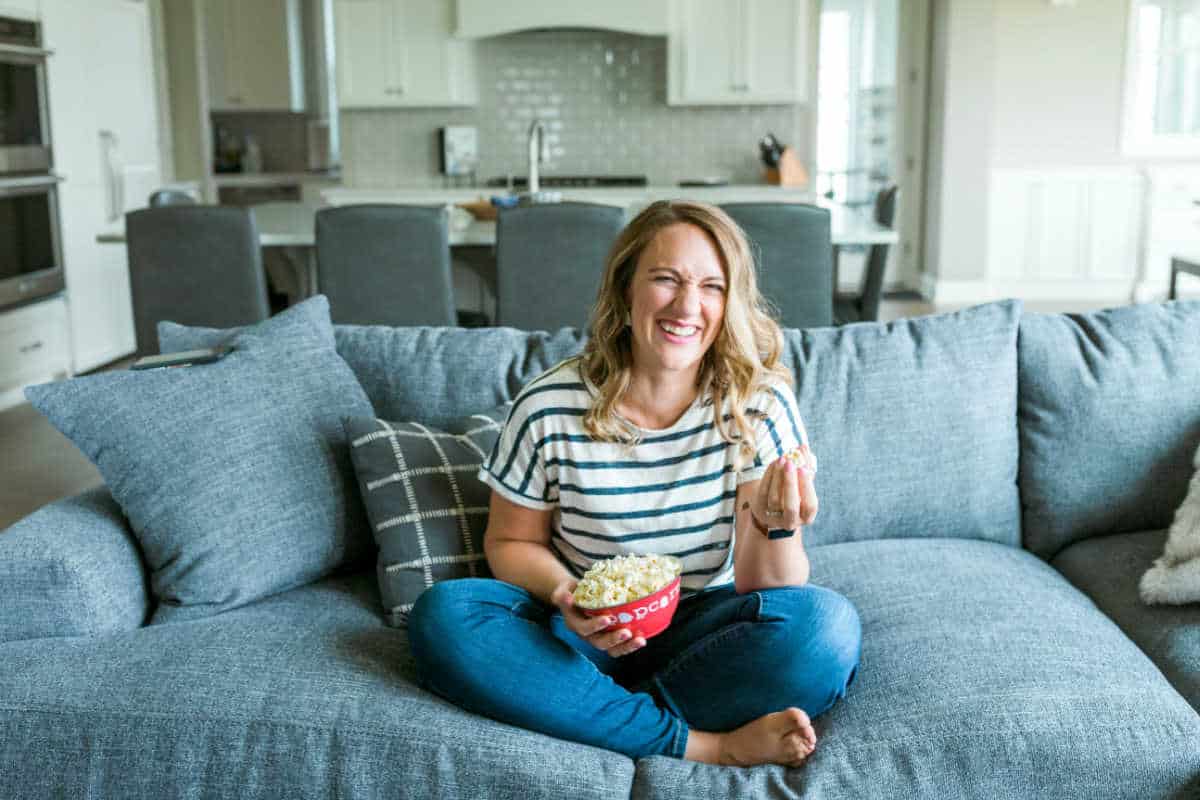 Julie eating popcorn on couch