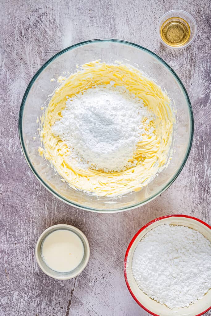 Overhead image of glass bowl with butter and powdered sugar