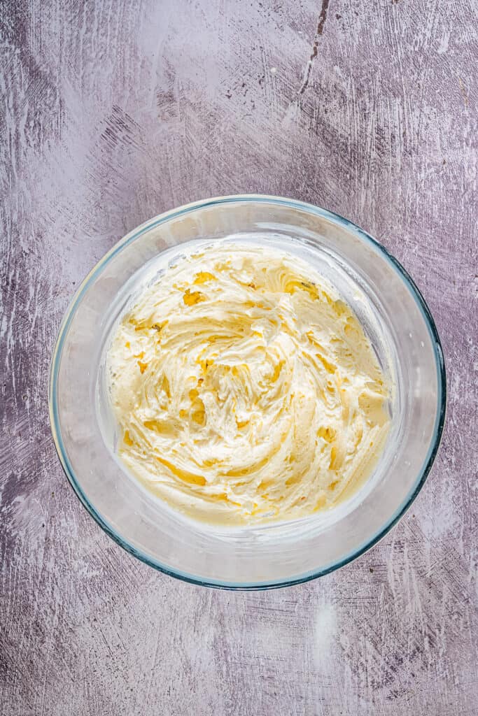 Overhead image of glass bowl mixed buttercream frosting