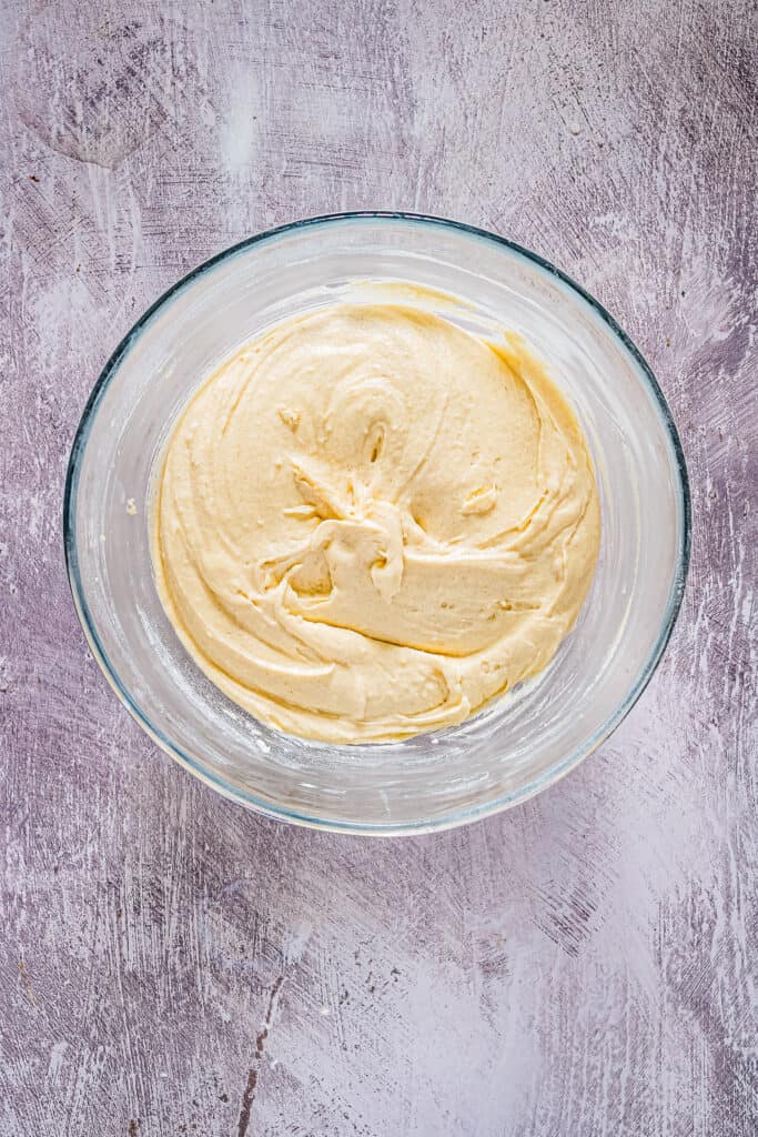 Vanilla cupcake batter in glass mixing bowl