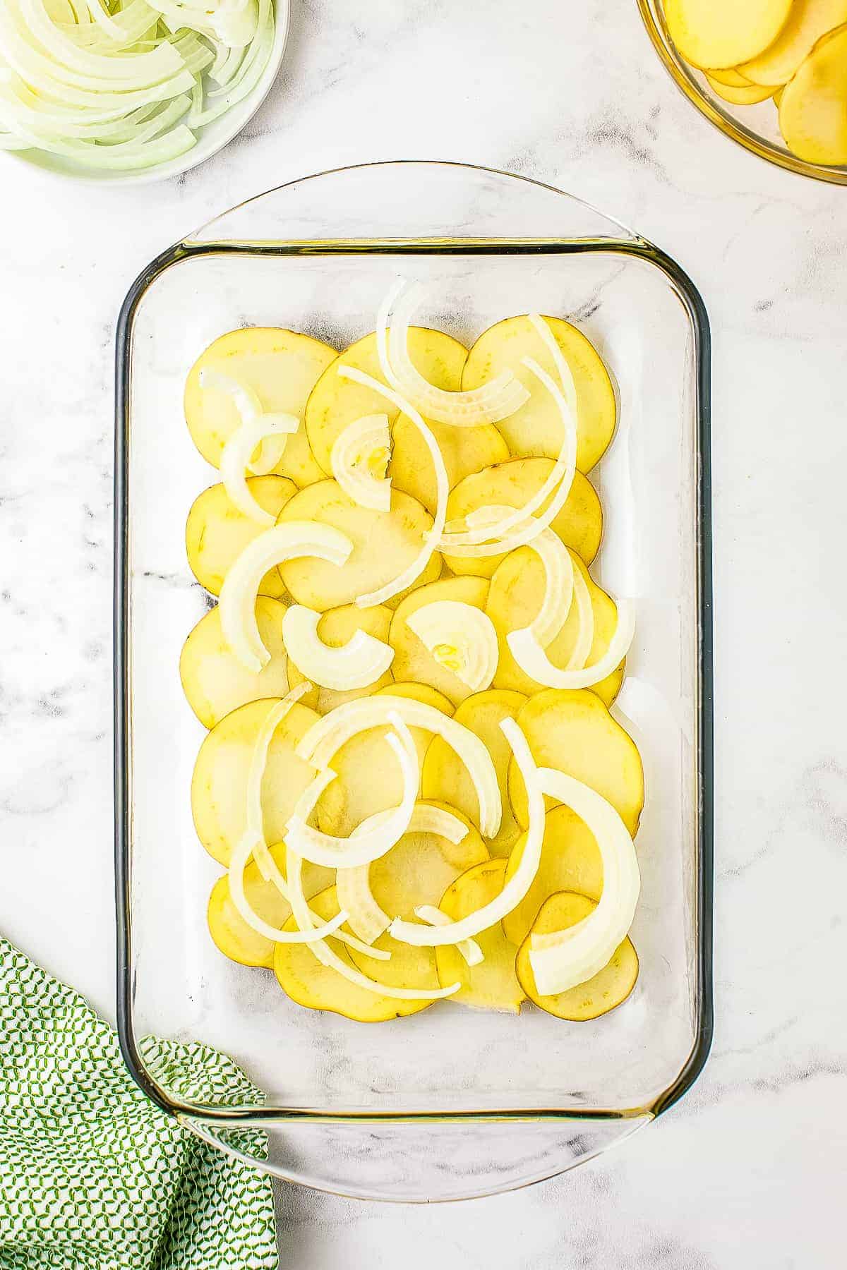 Glass pan with onions and potatoes