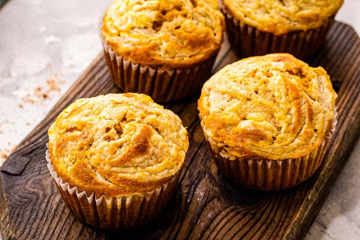 Pumpkin Cream Cheese Muffins on a wood cutting board