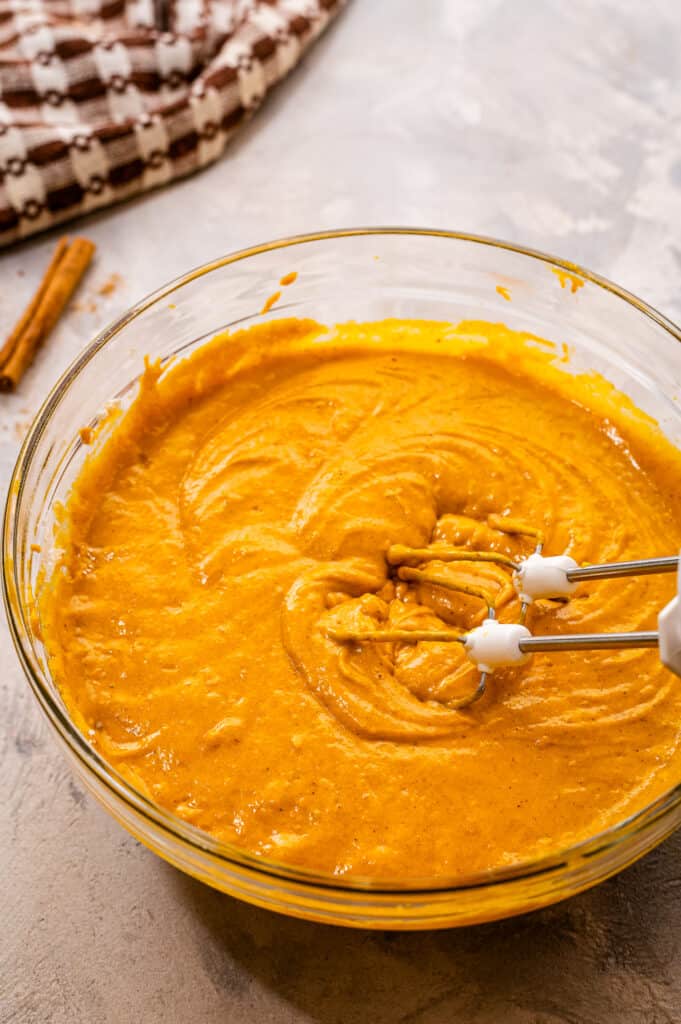 Pumpkin Muffin batter mixed together in glass bowl