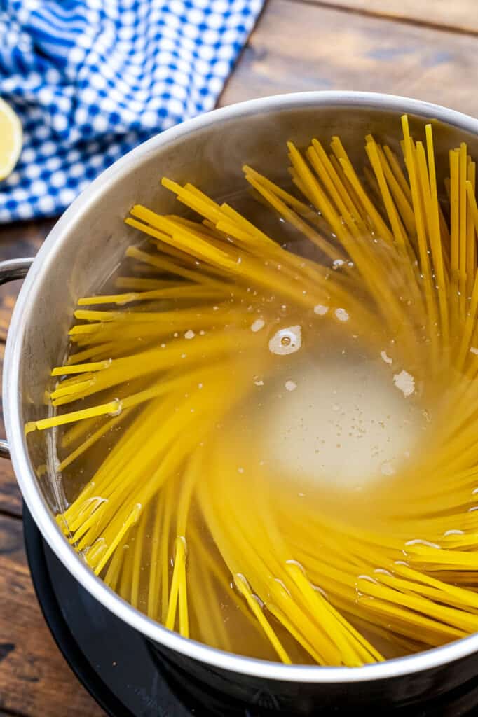 Saucepan with water and linguine noodles