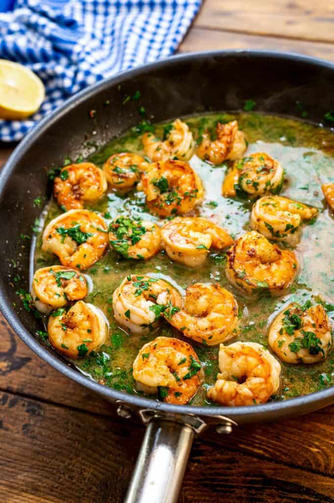 Shrimp in butter in a skillet with parsley