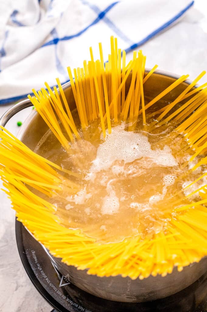 Boiling linguine noodles in saucepan