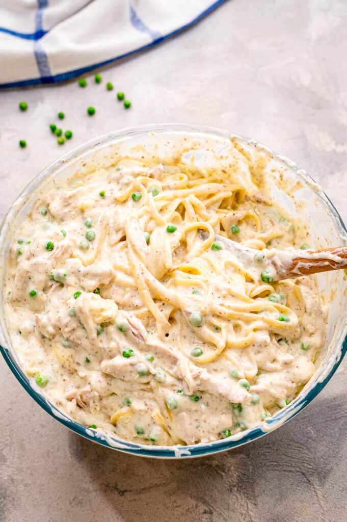Mixing turkey tetrazzini together in bowl