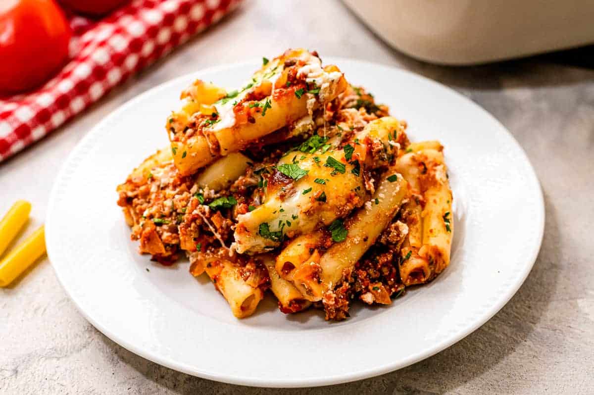 White plate with baked ziti on it