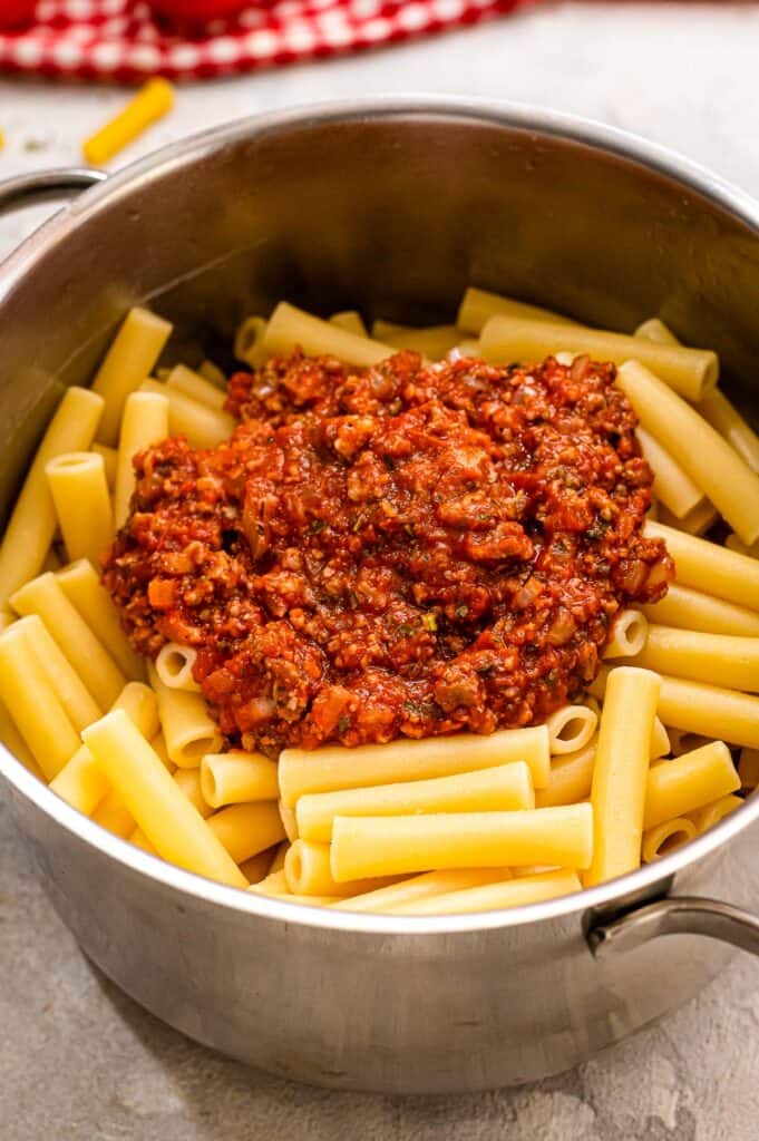 Saucepan with ziti noodles and meat sauce
