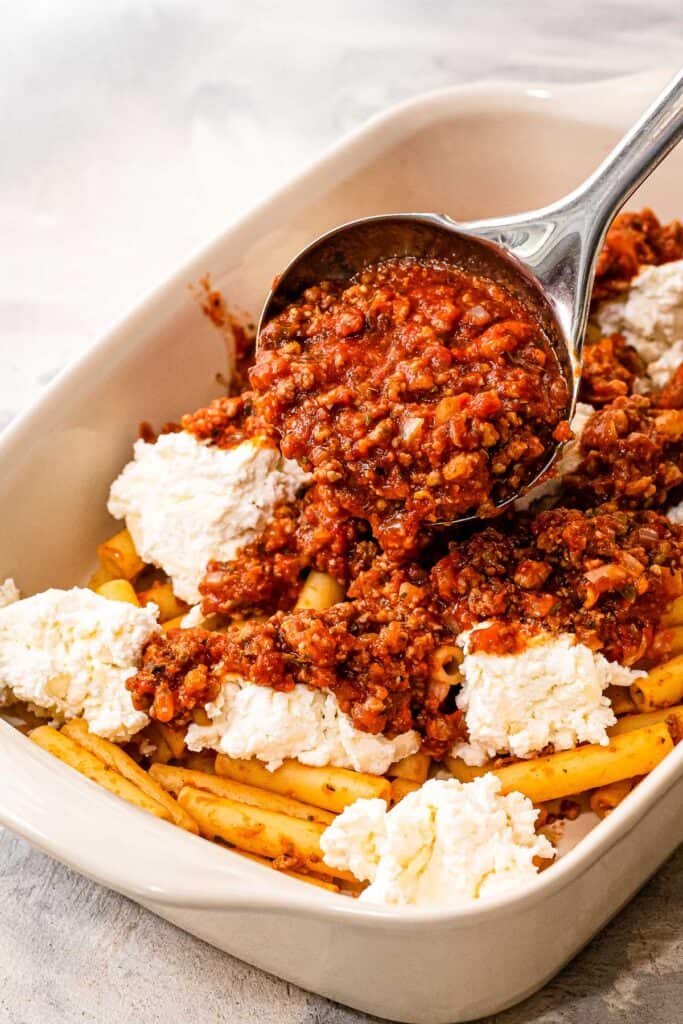 Casserole dish with layers of pasta, cheese and meat sauce