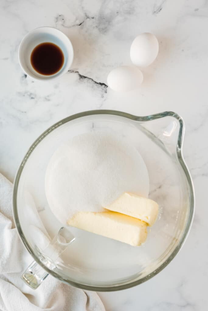 Glass bowl with stick of butter and white sugar