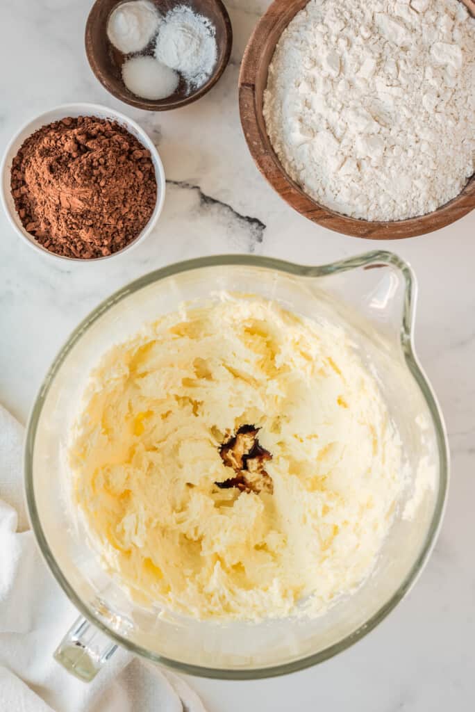 Glass bowl with stick of butter and white sugar creamed together and vanilla added