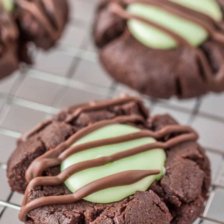 Chocolate Mint Thumbprint Cookie on wire rack with chocolate drizzle