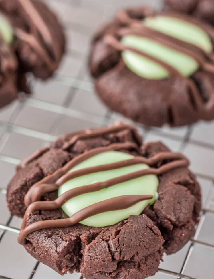 Chocolate Mint Thumbprint Cookie on wire rack with chocolate drizzle