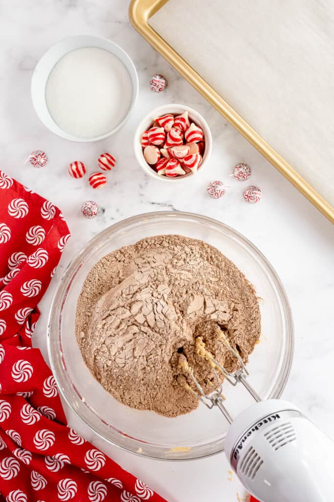 Hand mixer mixing cocoa powder and cookie batter
