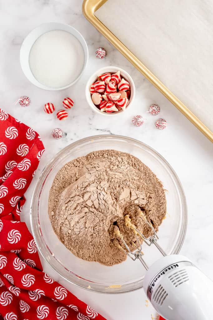 Hand mixer mixing cocoa powder and cookie batter