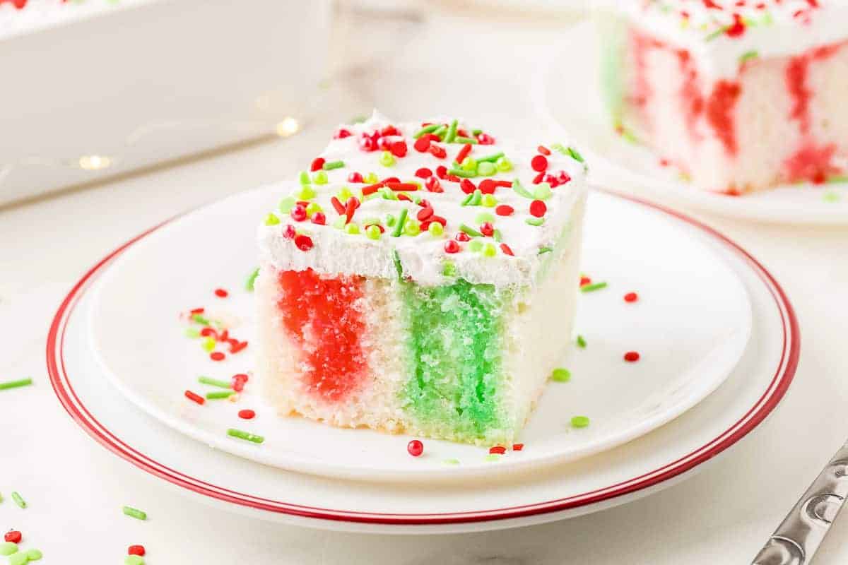 Piece of Christmas Poke Cake on a white plate 