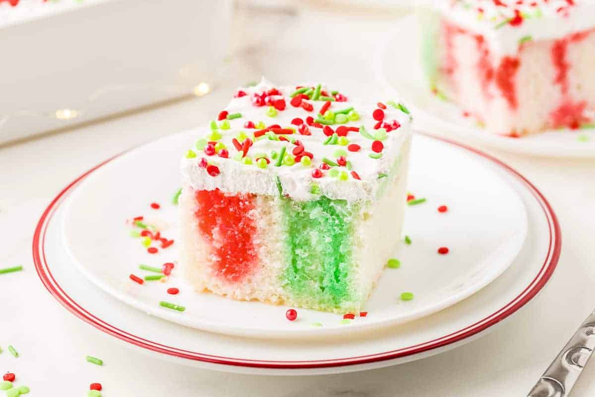 Piece of Christmas Poke Cake on a white plate