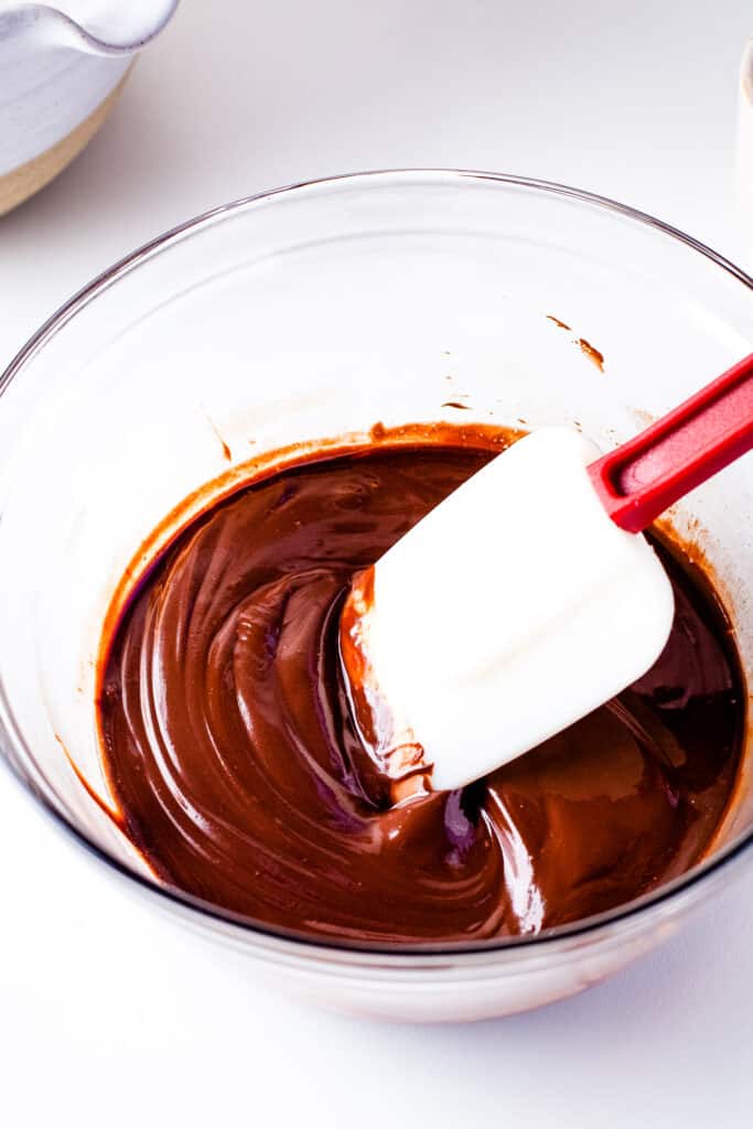 Stirring chocolate glaze for donuts