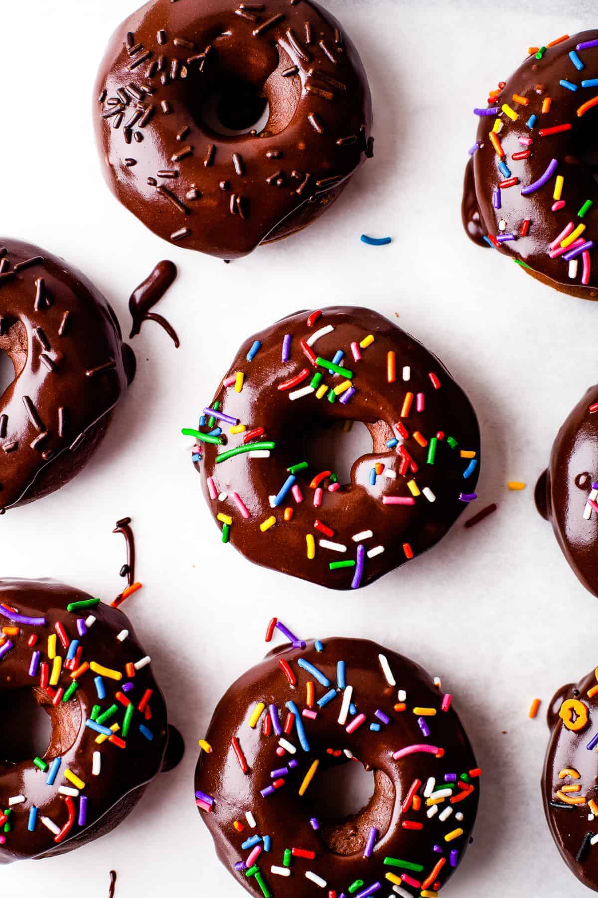 Overhead image of Frosted Baked Chocolate Donuts with sprinkles